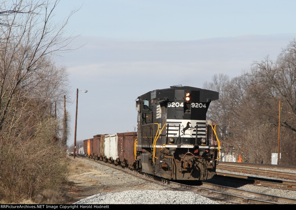 NS 9204 leads a work train out of the yard behind train 94Q